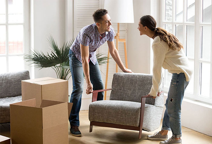 Couple moving furniture | Ronnie's Carpets & Flooring